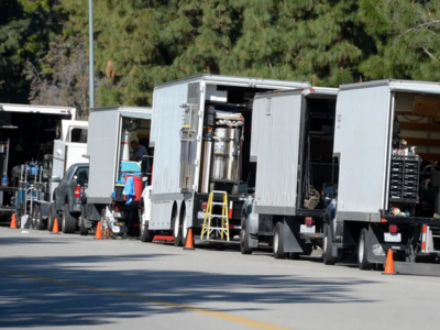 film production crew with transport vehicles and mobile toilets on site